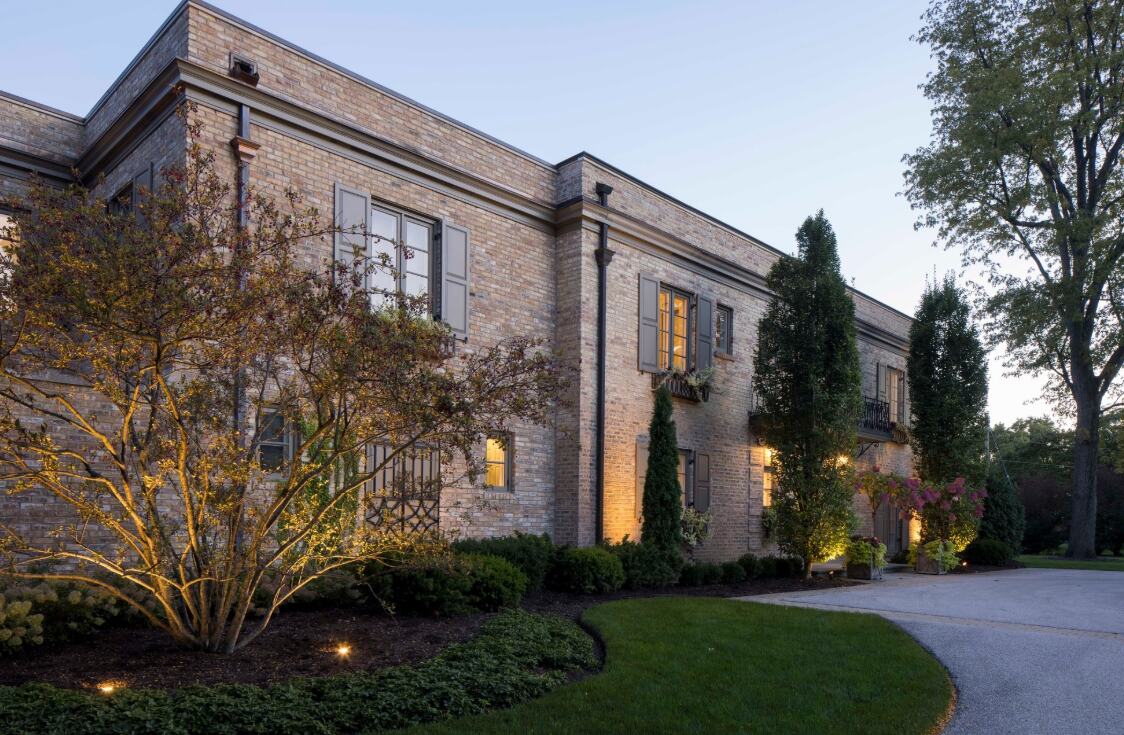 driveway contractor in Wheeling, IL: a curving paver driveway approach to a brick home