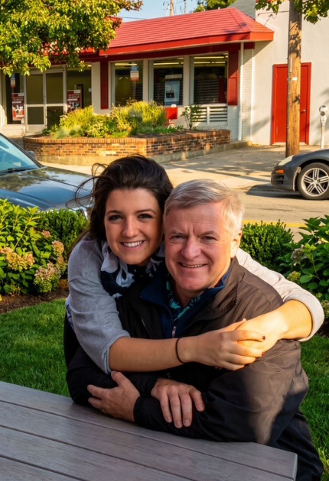 Bob Bertog smiling with a young woman, their arms around each other.