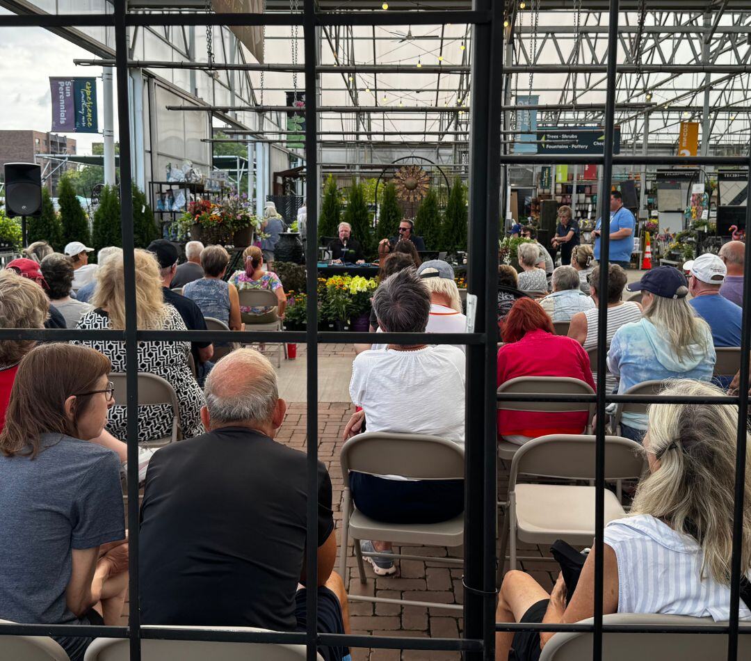 Audience seated under the greenhouse at Lurvey Home & Garden for the Keepin' It Green broadcast.